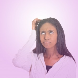 woman scratching head, thinking daydreaming confused